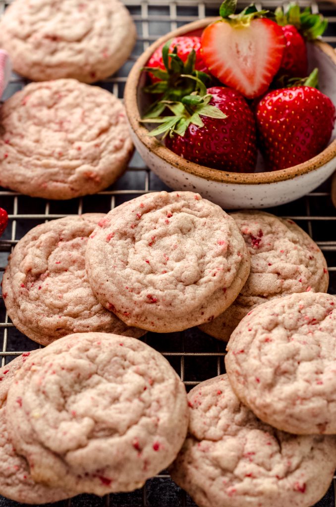 Strawberry cookies on a wire cooling rack.