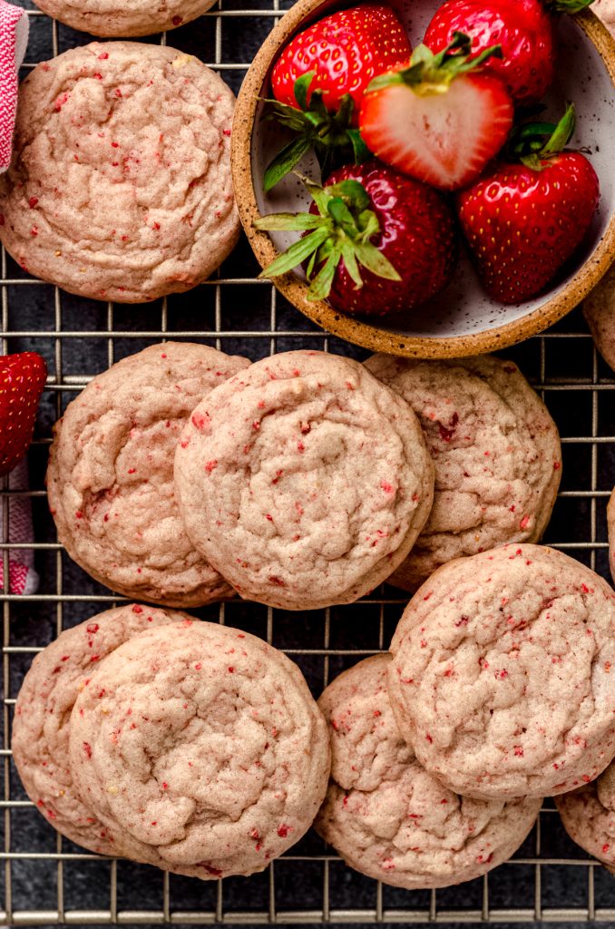 Aerial photo of strawberry cookies on a wire rack.