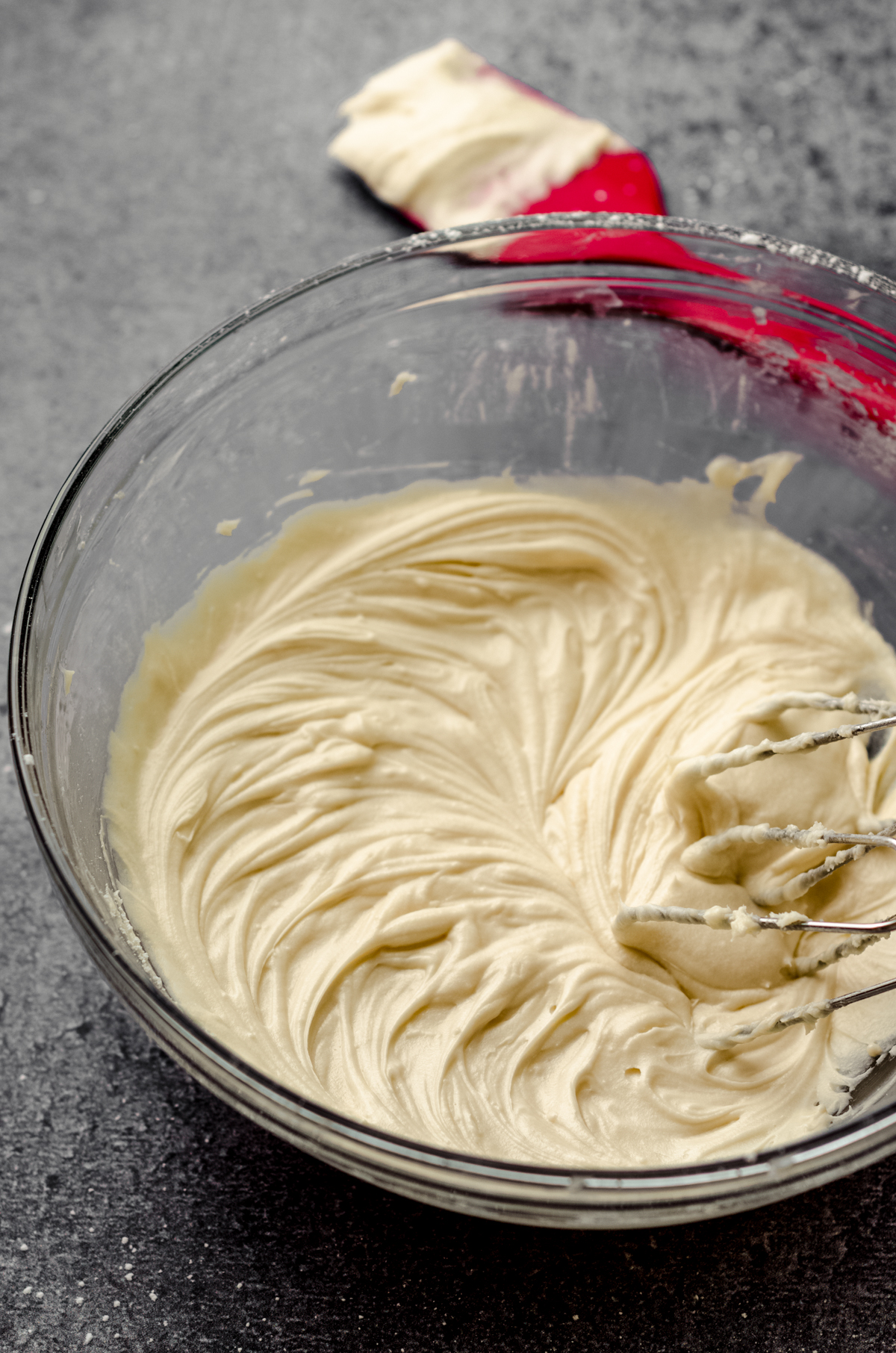 Bowl of vanilla buttercream in a bowl with beaters.