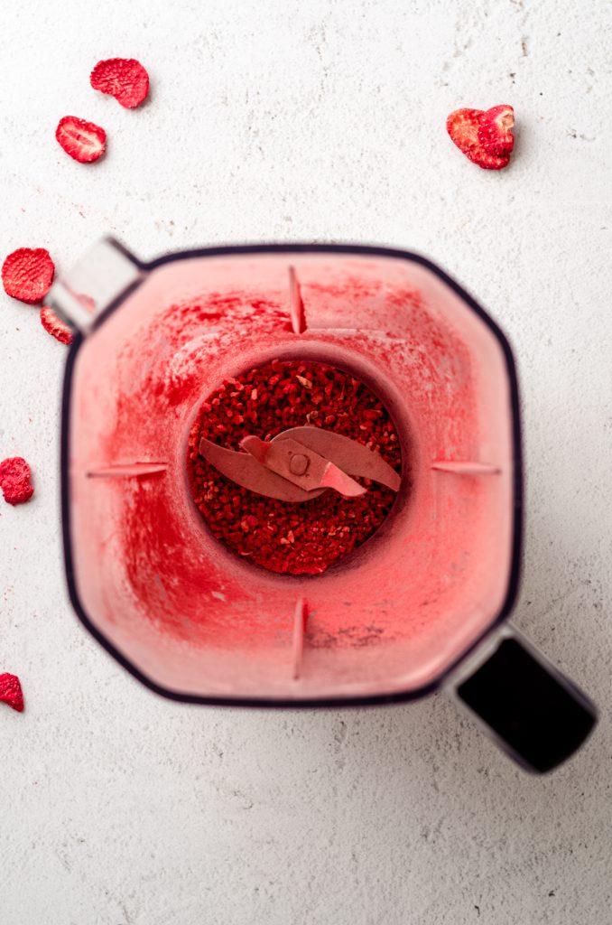 Aerial photo of blender full of freeze-dried strawberry powder.