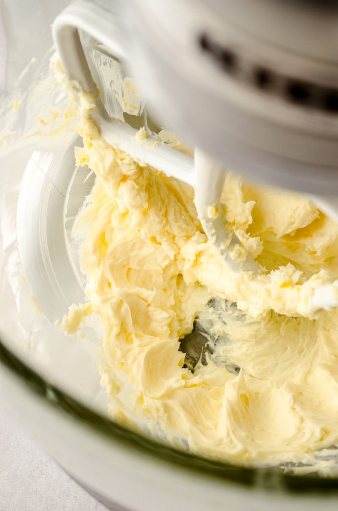 Lemon buttercream in the bowl of a stand mixer.