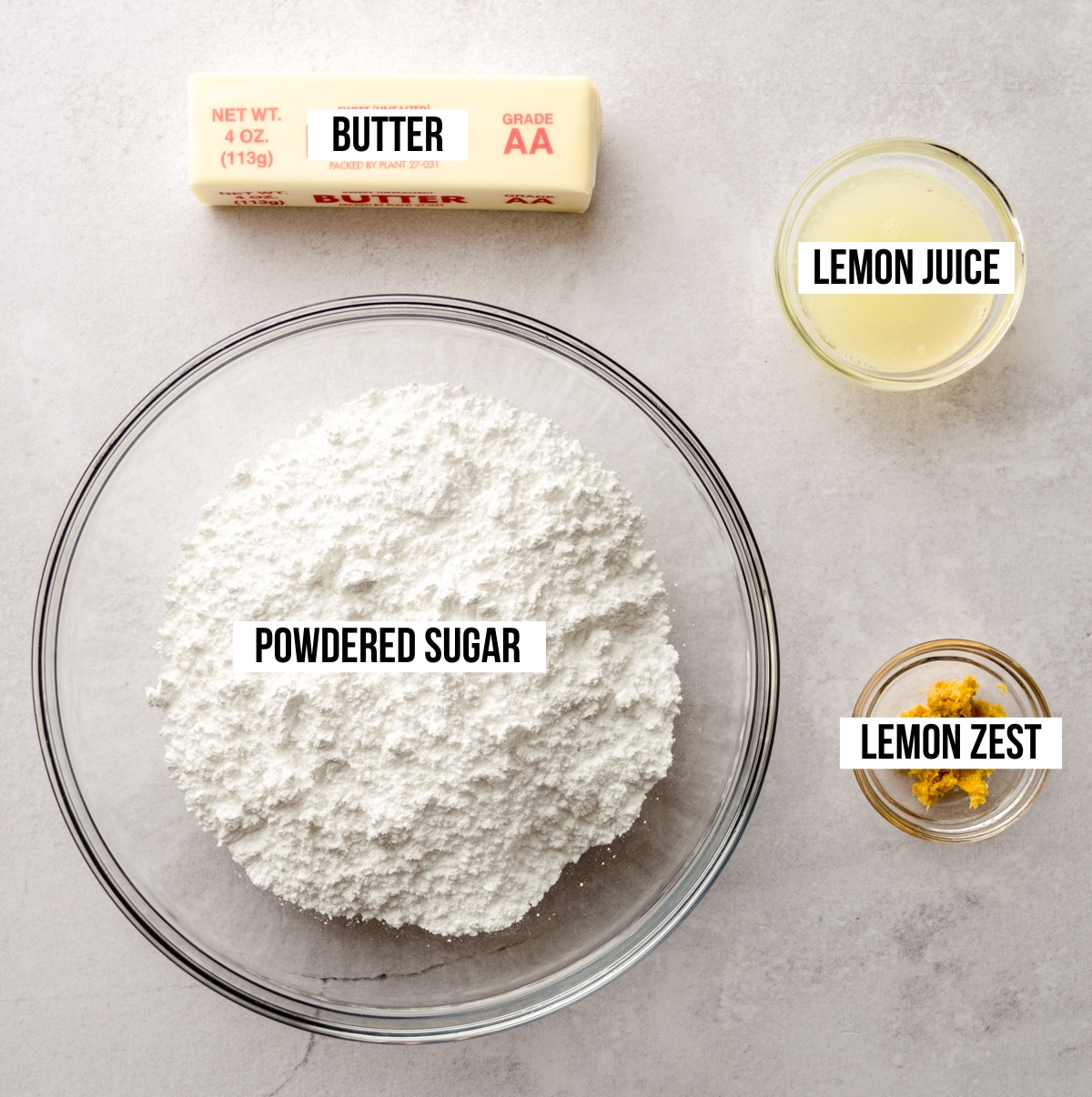 Aerial photo of ingredients for lemon buttercream with text overlay labeling each ingredient.