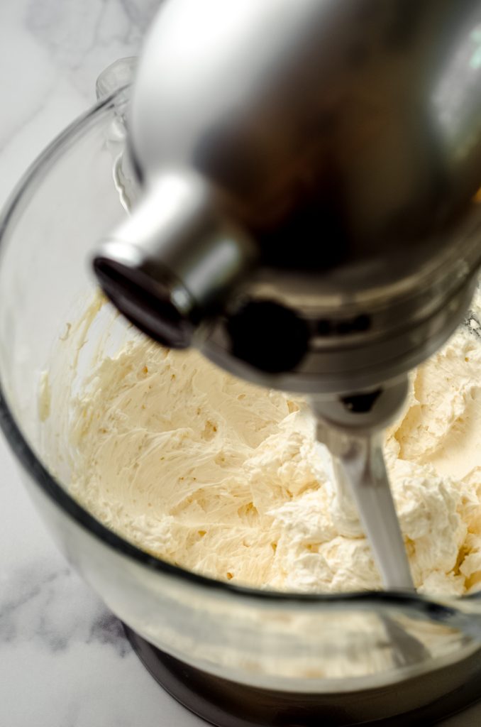 Marshmallow buttercream in the bowl of a stand mixer.