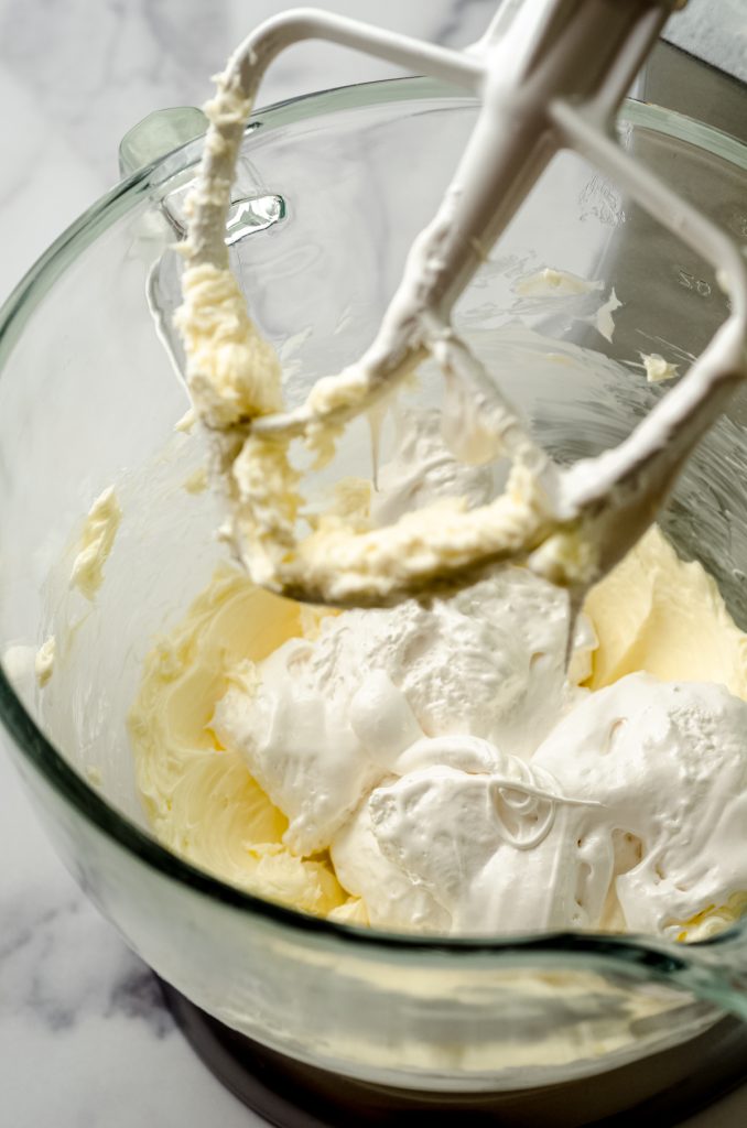 Ingredients for marshmallow buttercream in the bowl of a stand mixer.