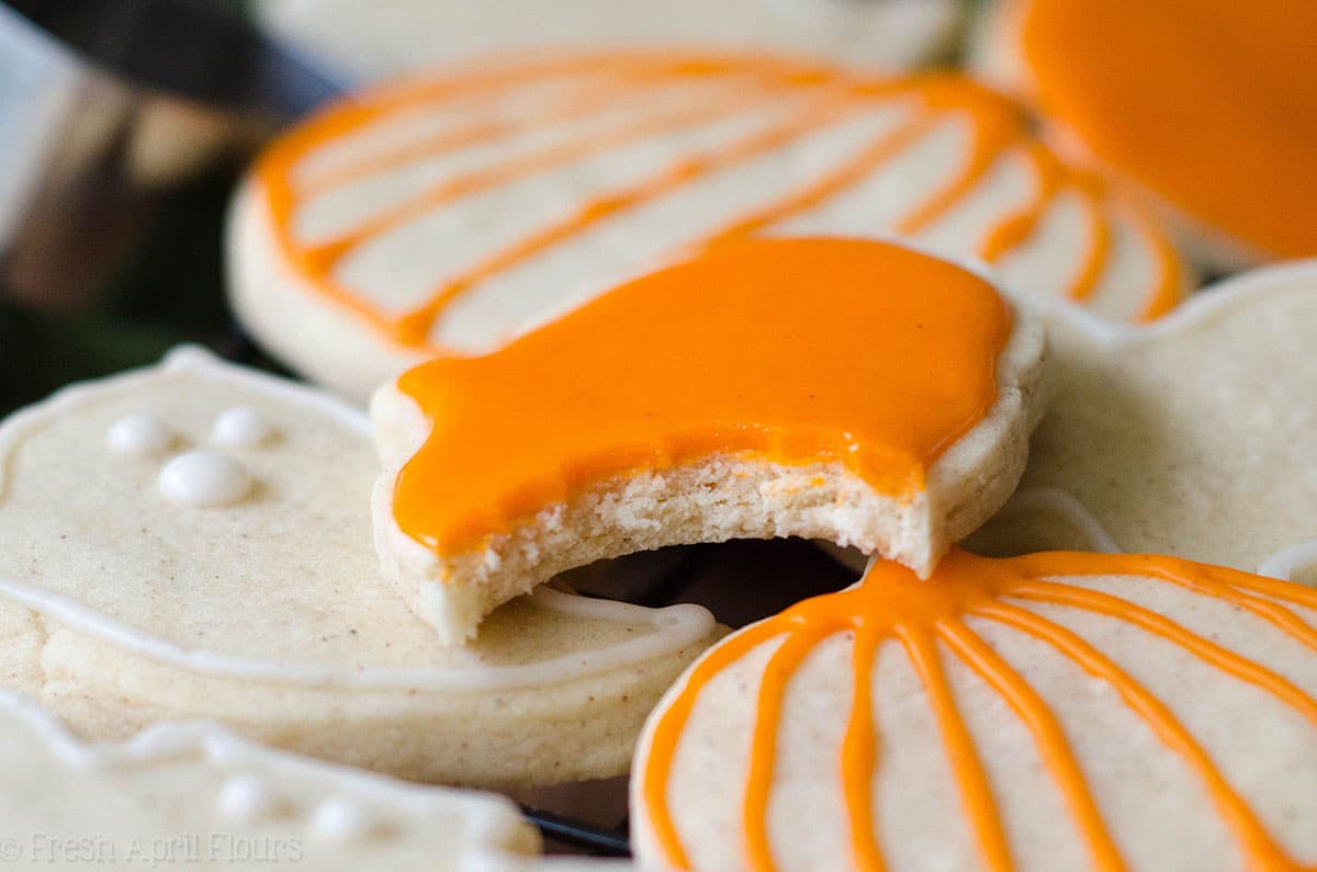pumpkin cut out cookie with orange icing on it