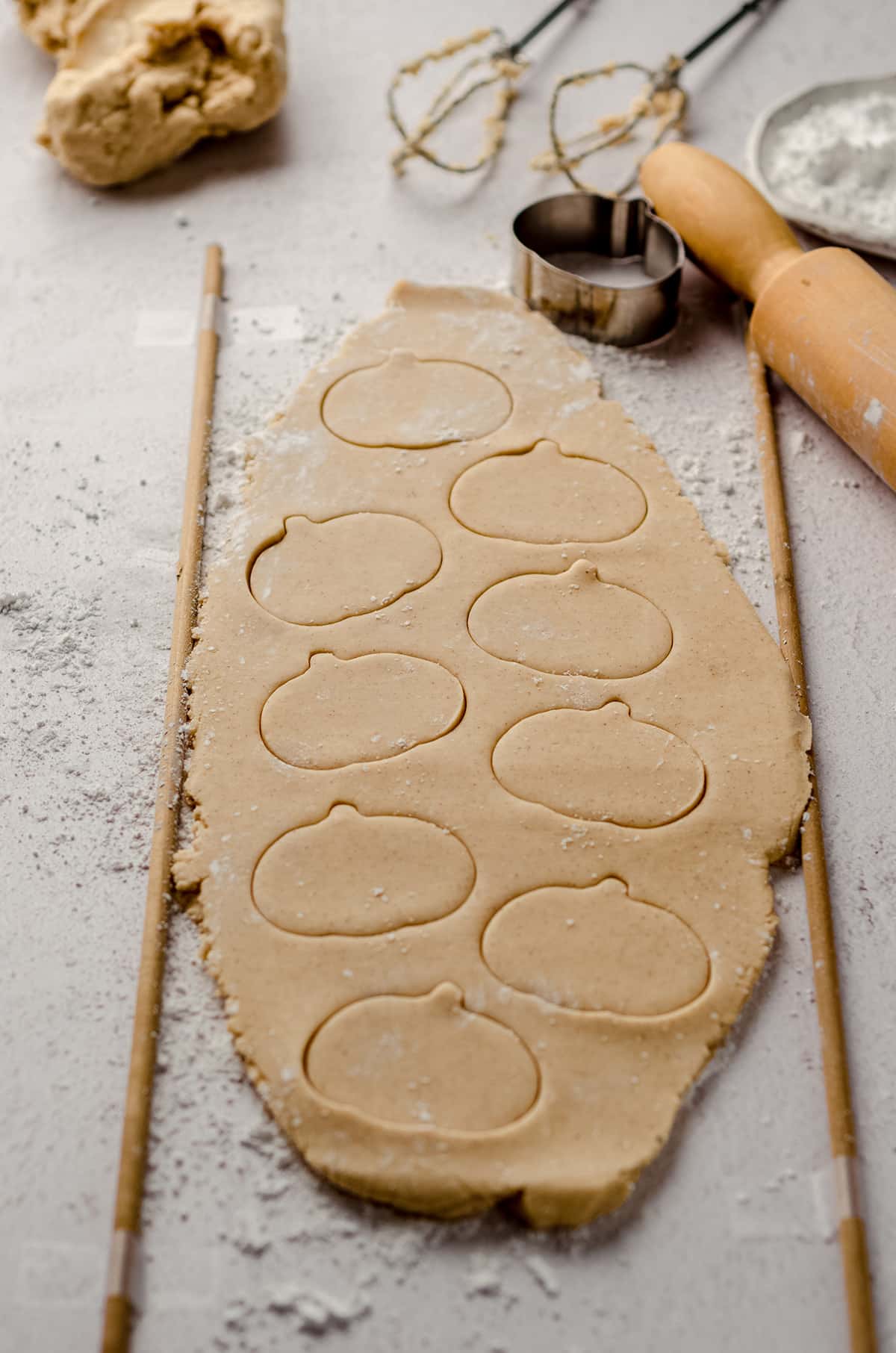 pumpkin shapes cut into pumpkin sugar cookie dough