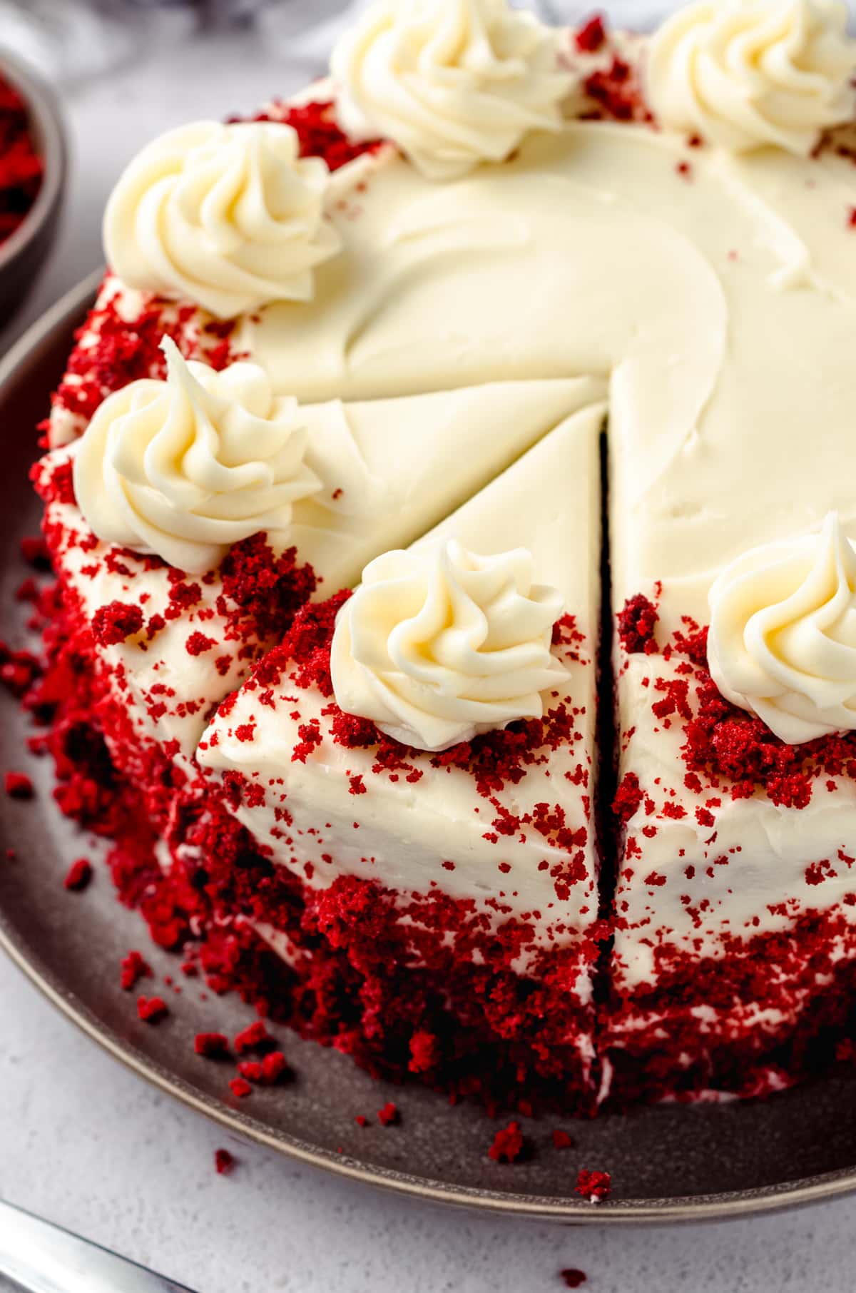 A red velvet cake with slice lines cut into it.