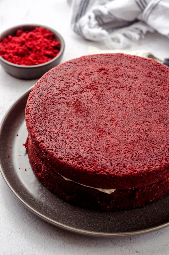 A stacked red velvet cake ready to be frosted.
