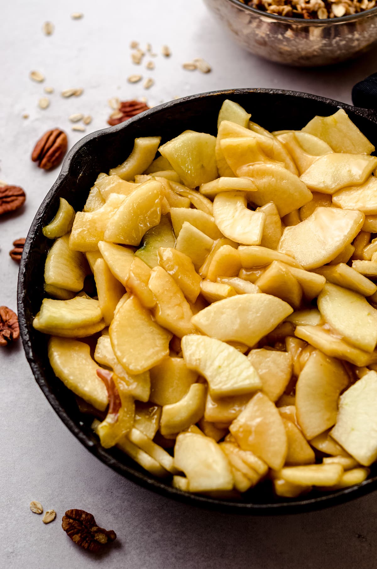 apples in a cast iron skillet to make apple crisp