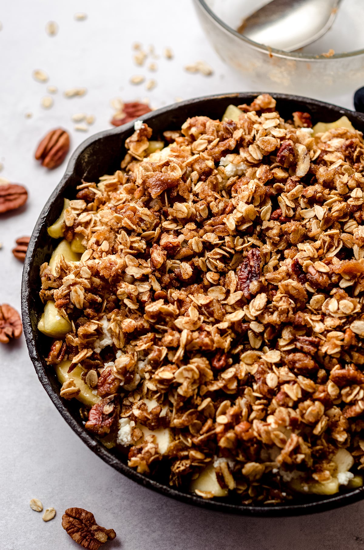 uncooked apple crisp in a skillet ready to bake