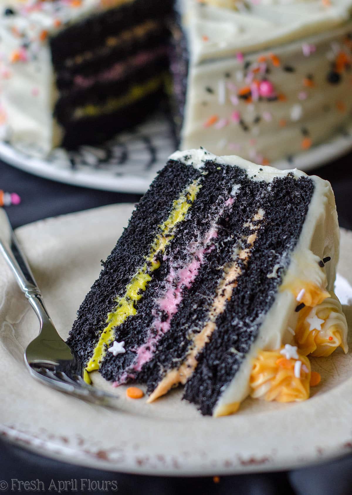slice of black velvet layer cake on a plate