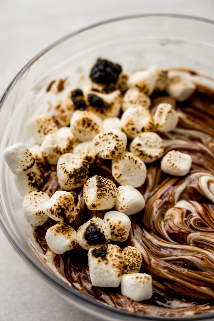 S'mores dip in a bowl with toasted marshmallows on top.