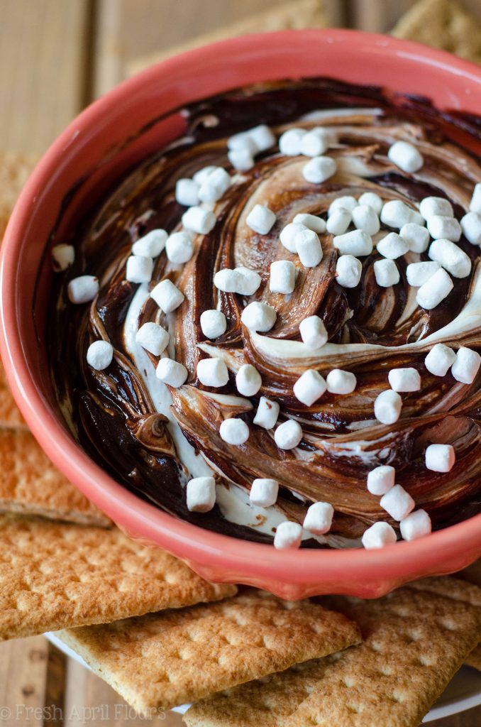 S'mores Dip: An easy gluten free dip made with marshmallow buttercream swirled with chocolate ganache. Serve with graham crackers or your favorite crunchy dipper and have the taste of summer all year long!