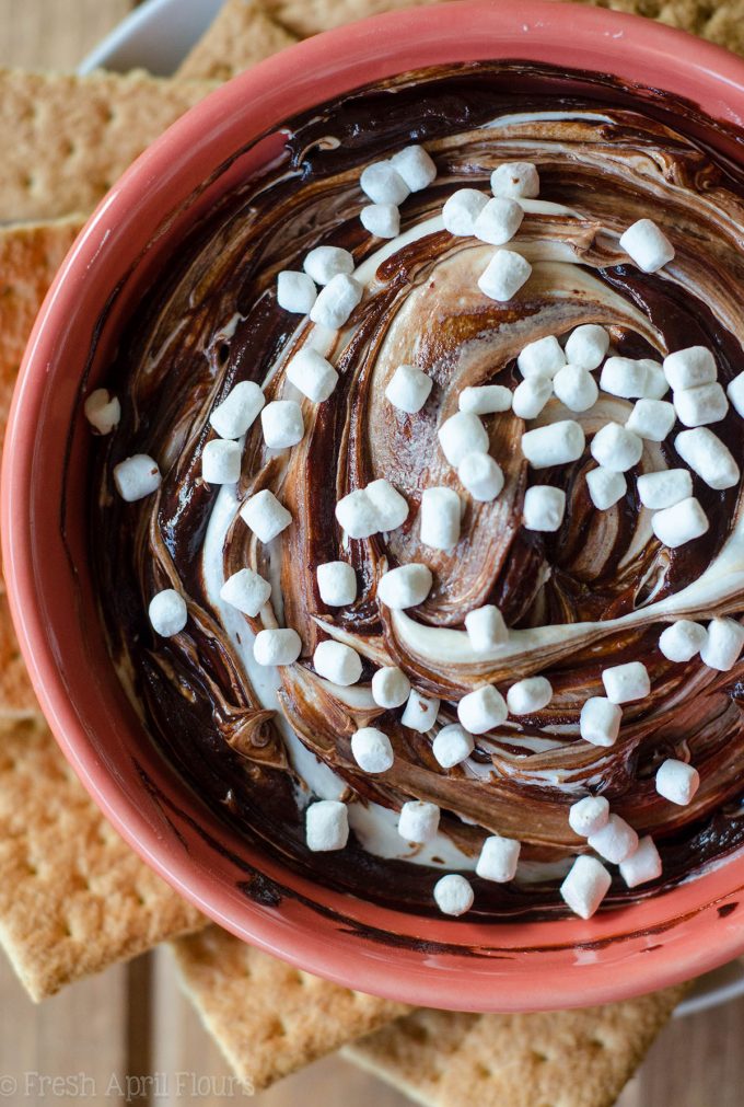 S'mores Dip: An easy gluten free dip made with marshmallow buttercream swirled with chocolate ganache. Serve with graham crackers or your favorite crunchy dipper and have the taste of summer all year long!