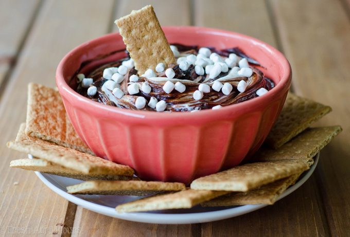 S'mores Dip: An easy gluten free dip made with marshmallow buttercream swirled with chocolate ganache. Serve with graham crackers or your favorite crunchy dipper and have the taste of summer all year long!