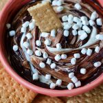 S'mores Dip: An easy gluten free dip made with marshmallow buttercream swirled with chocolate ganache. Serve with graham crackers or your favorite crunchy dipper and have the taste of summer all year long!