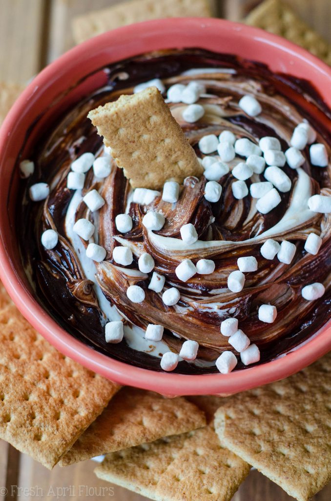 S'mores Dip: An easy gluten free dip made with marshmallow buttercream swirled with chocolate ganache. Serve with graham crackers or your favorite crunchy dipper and have the taste of summer all year long!