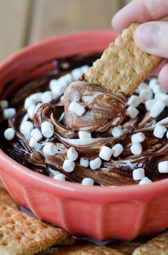 S'mores Dip: An easy gluten free dip made with marshmallow buttercream swirled with chocolate ganache. Serve with graham crackers or your favorite crunchy dipper and have the taste of summer all year long!