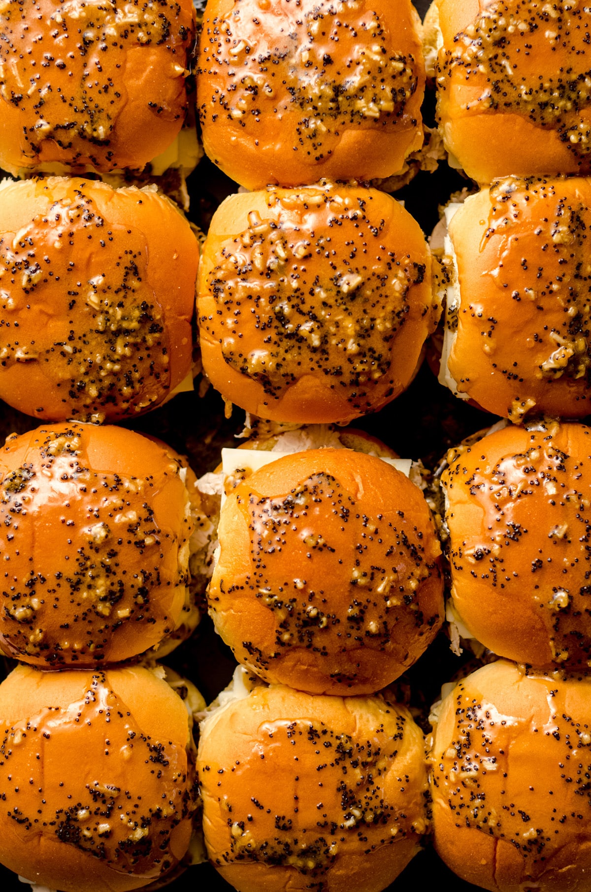aerial photo of turkey and cheese sliders with a honey mustard glaze ready to bake