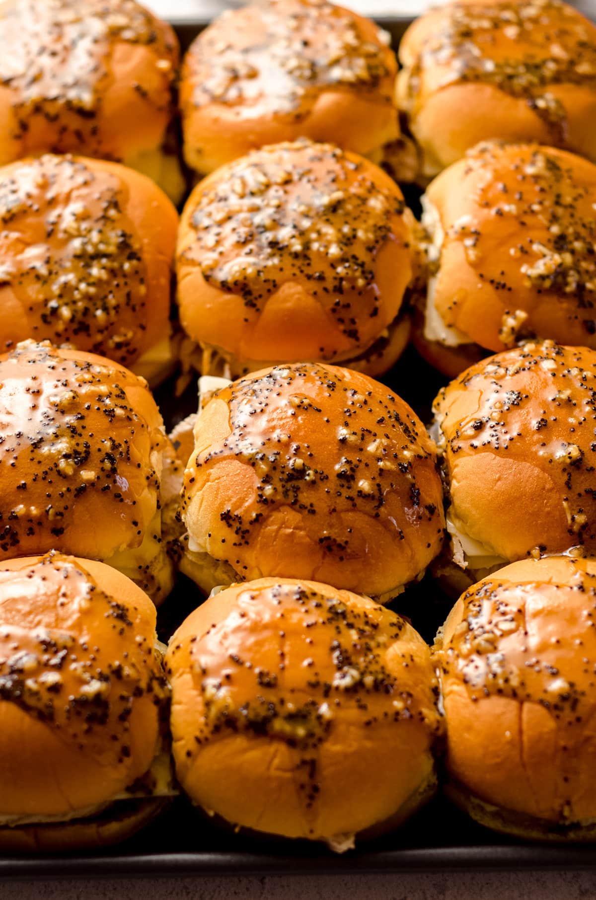 aerial photo of turkey and cheese sliders with a honey mustard glaze ready to bake