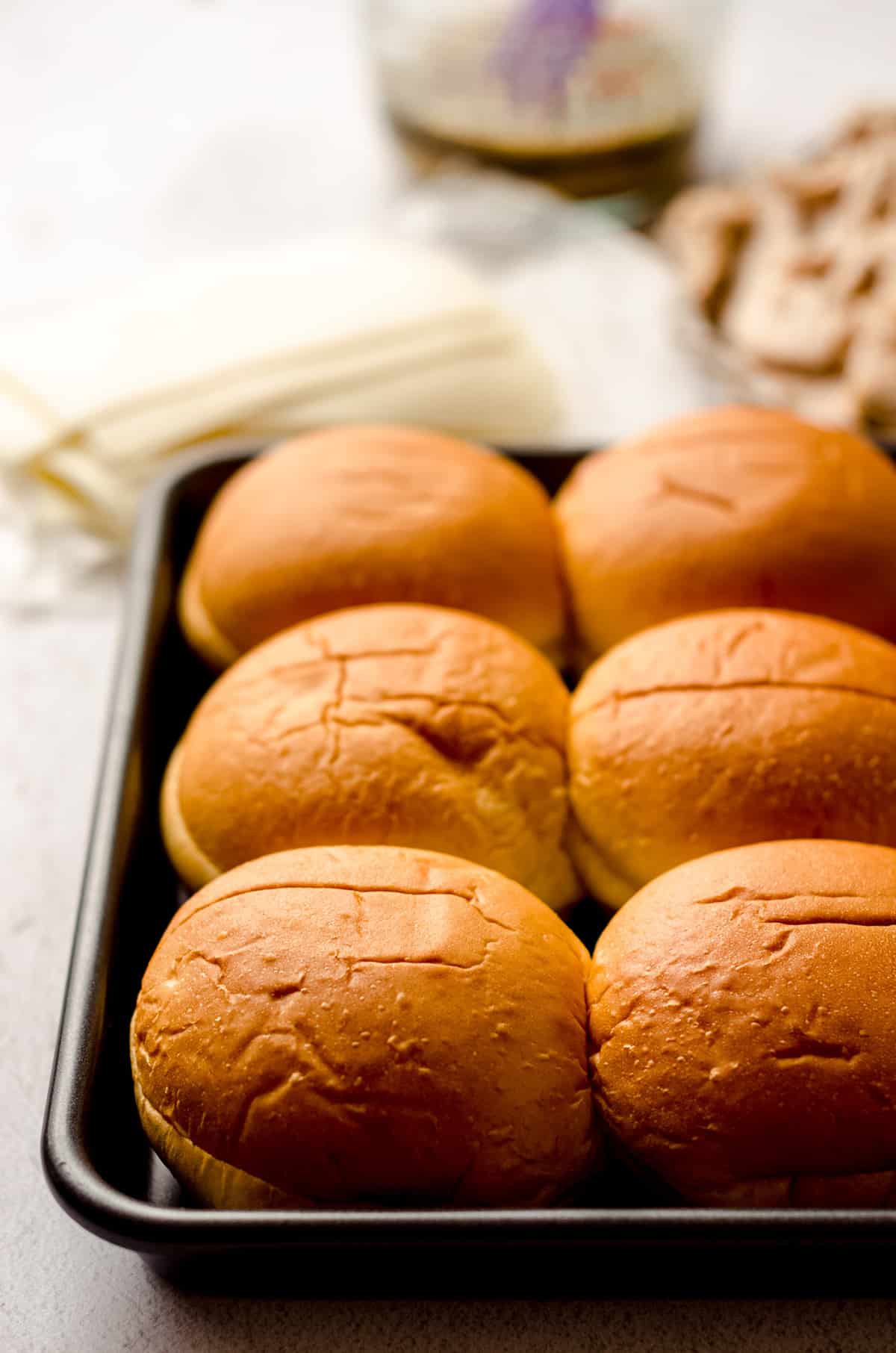 slider rolls in a baking dish prepped to make turkey and cheese sliders