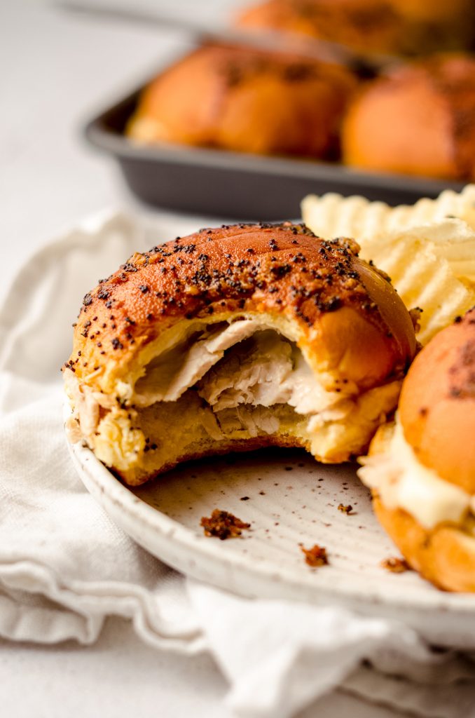 turkey slider on a plate with a bite taken out of it