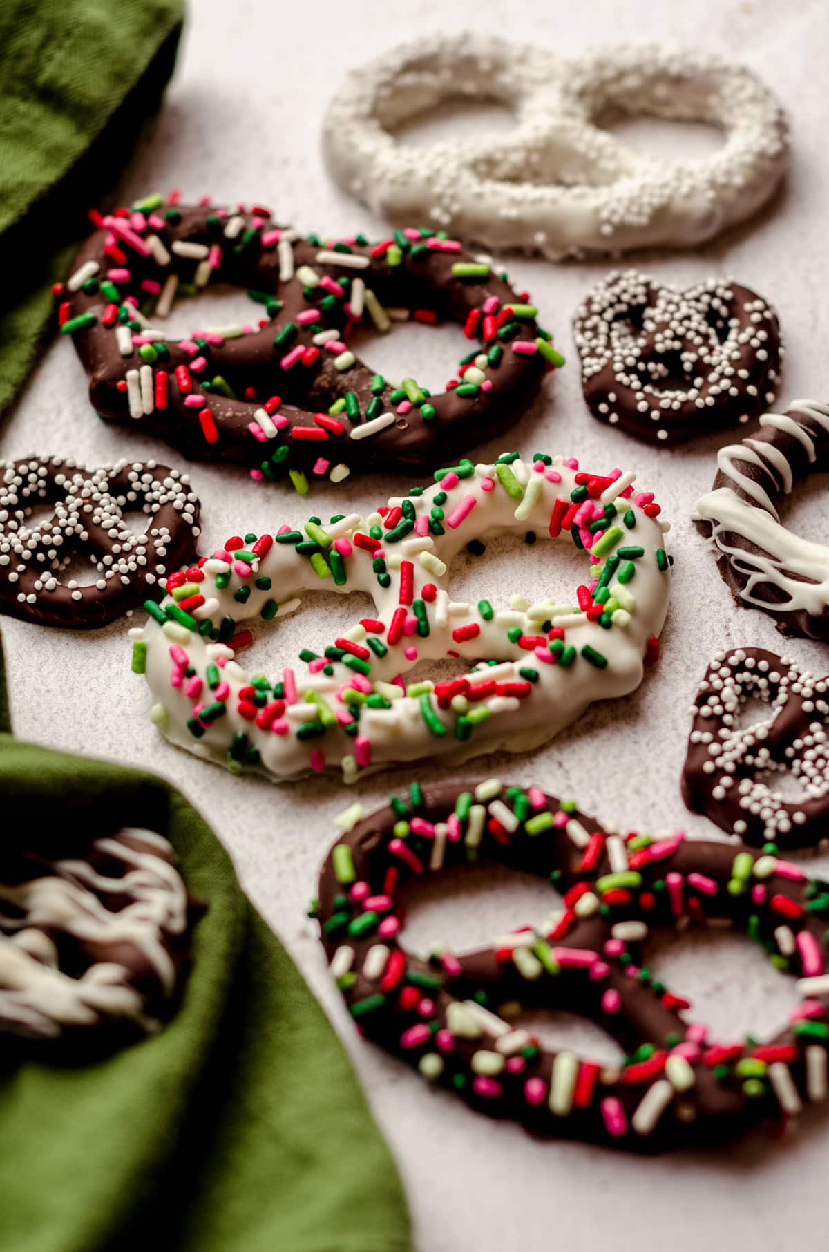 chocolate covered pretzels decorated with assorted sprinkles