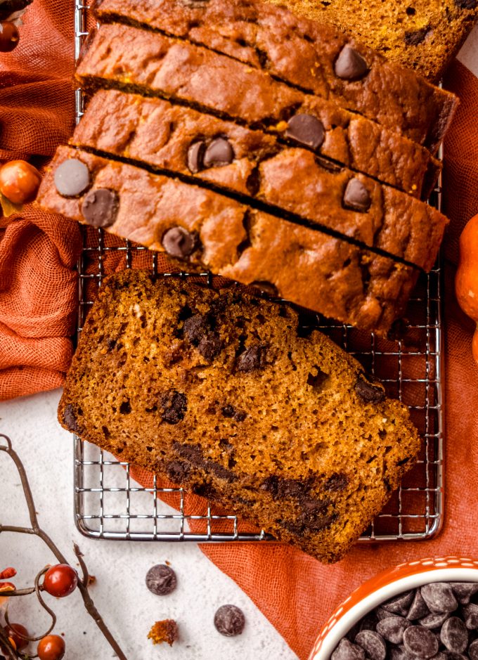 Aerial photo of chocolate chip pumpkin bread slices on a wire cooling rack.