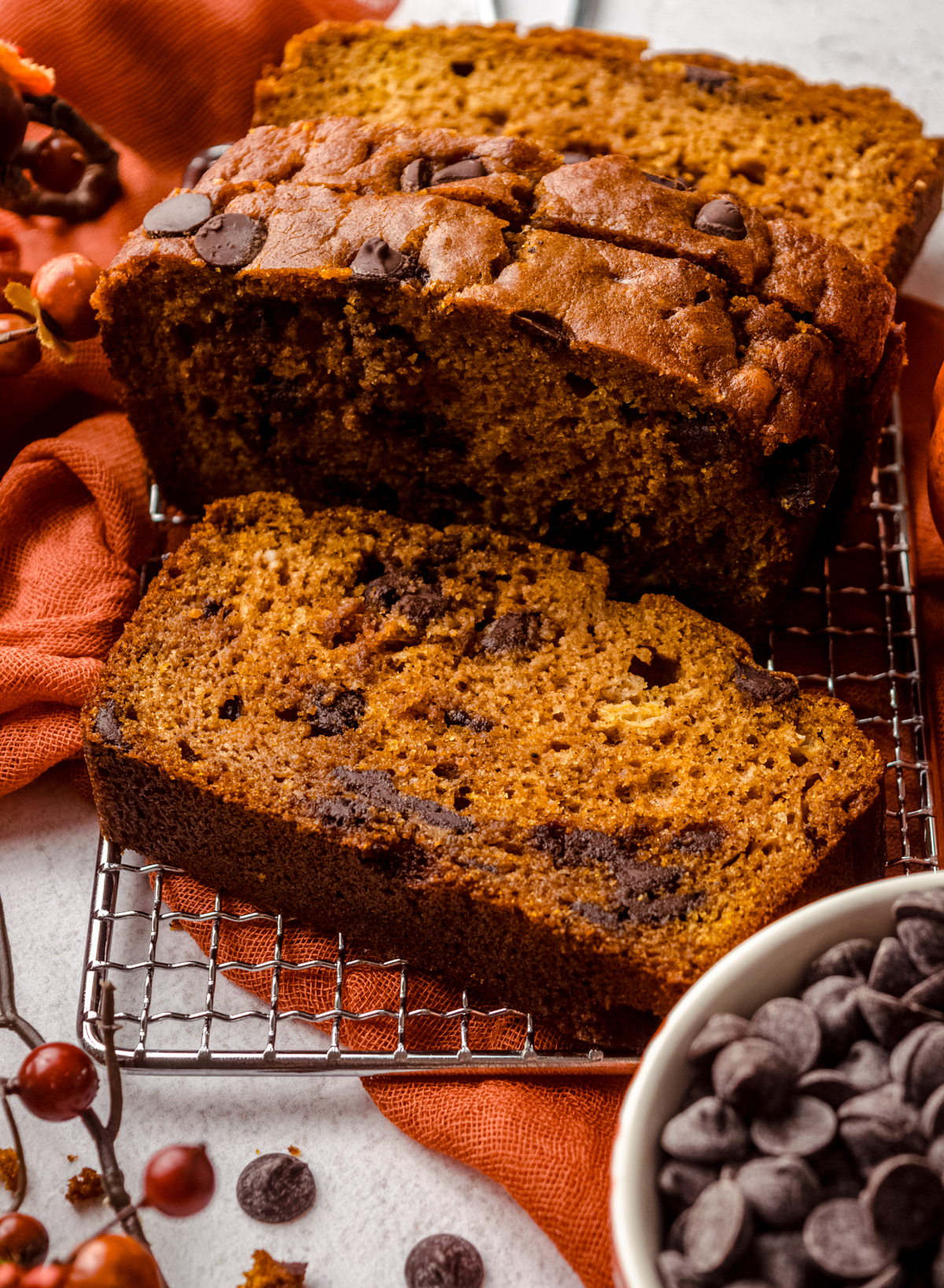 Aerial photo of chocolate chip pumpkin bread slices on a wire cooling rack.