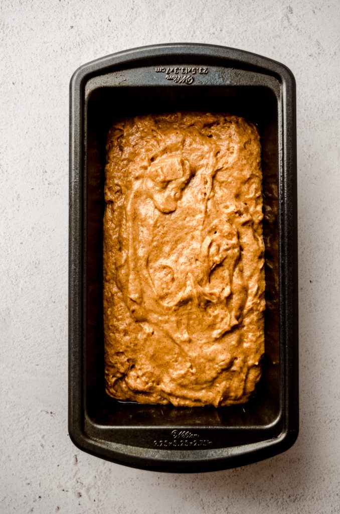 Aerial photo of pumpkin bread batter in a loaf pan.