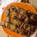 Aerial photo of slices of chocolate chip pumpkin bread on a pumpkin shaped plate.