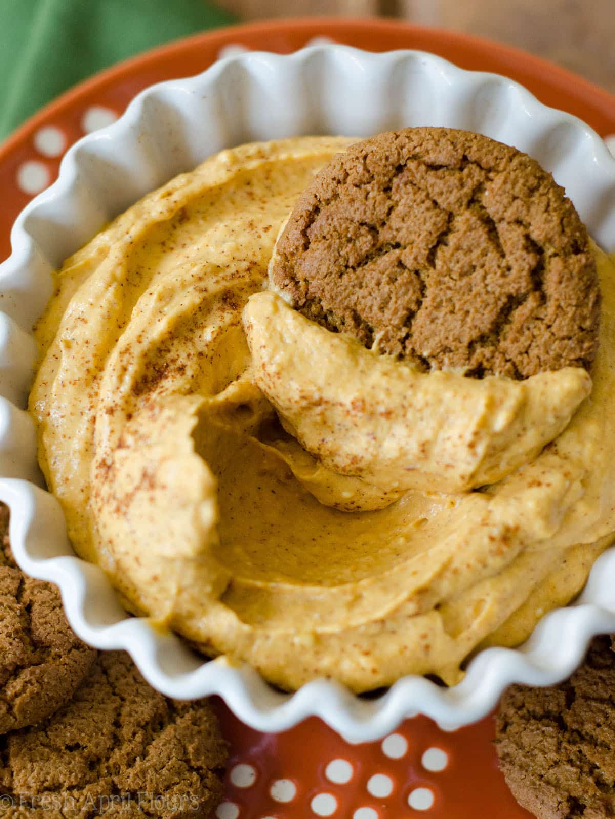 bowl of pumpkin dip with a gingersnap in it