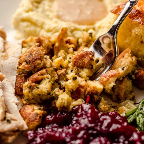 a fork grabbing a bite of thanksgiving bread stuffing