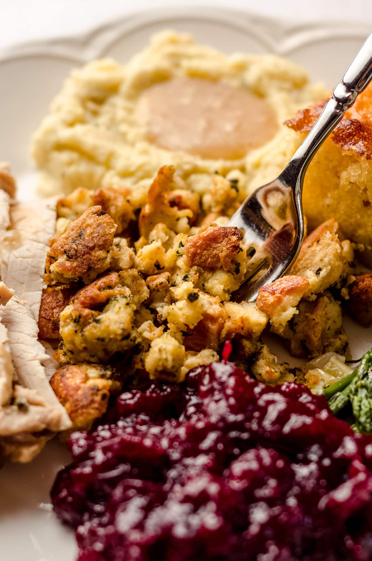 a fork grabbing a bite of thanksgiving bread stuffing