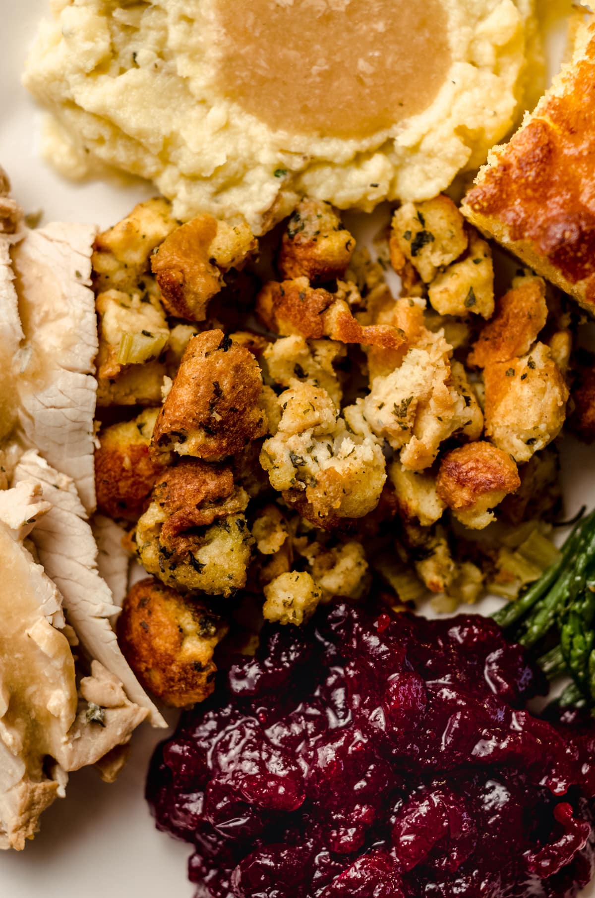 traditional stuffing on a plate with other thanksgiving sides