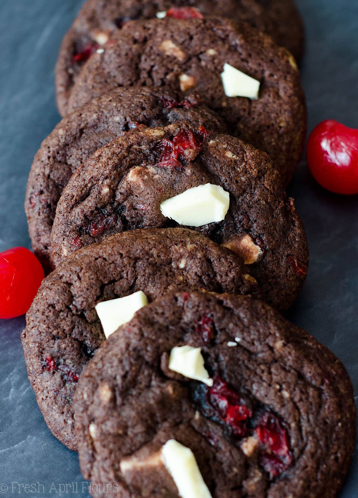 Black Forest Cookies: Soft and chewy chocolate cookies filled with creamy white chocolate chunks and sweet maraschino cherry pieces.