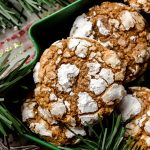 Aerial photo of gingerbread crinkle cookies sitting in a green tree shaped dish.