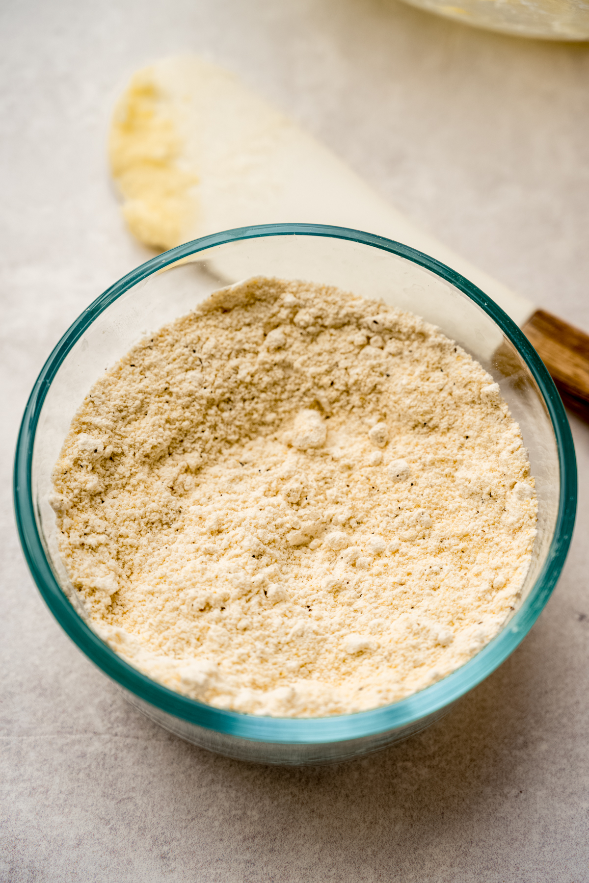 A glass bowl of dry ingredients for lemon pepper slice and bake cookies.