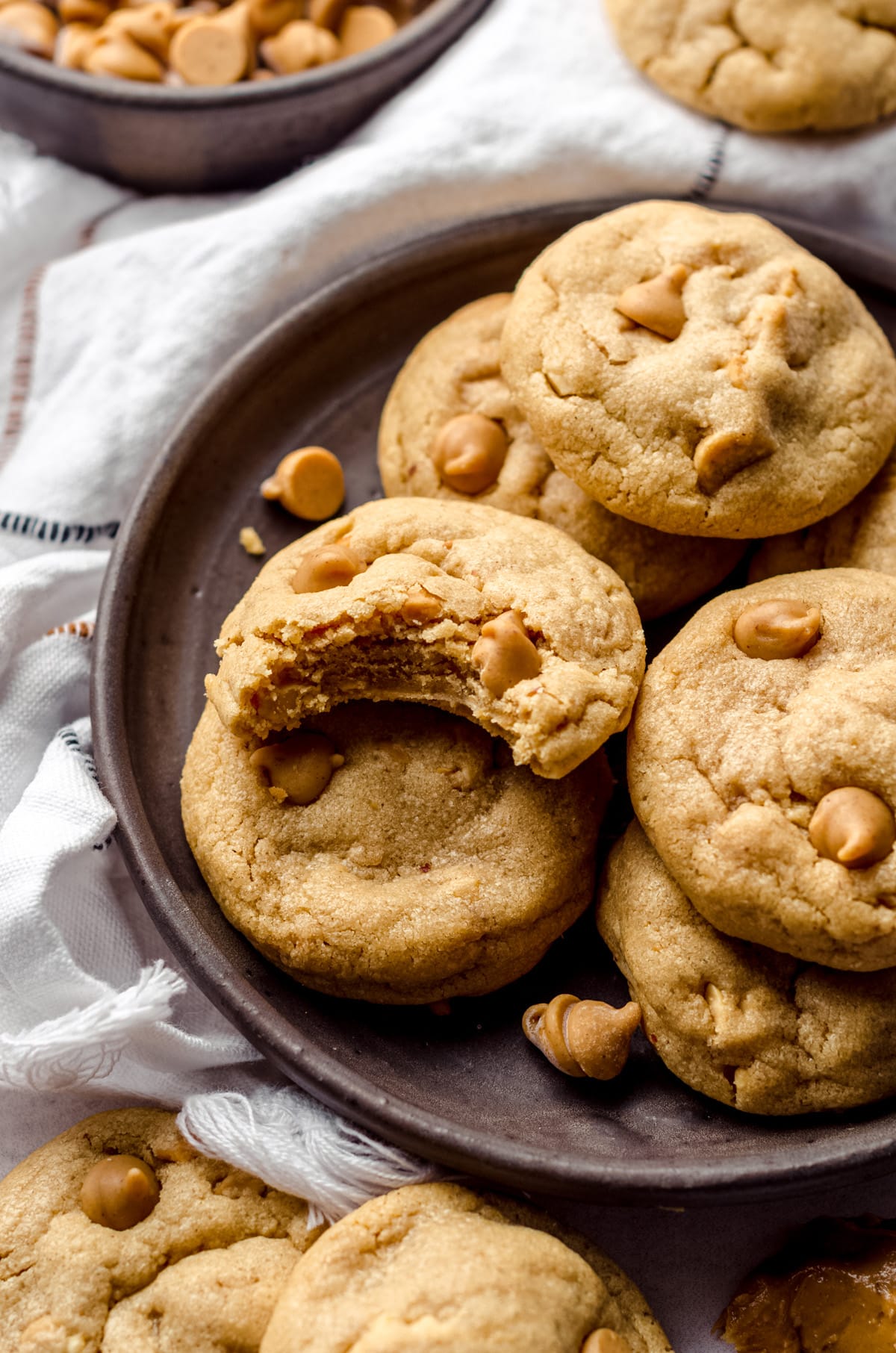 ultimate peanut butter cookies on a plate with a bite taken out of one