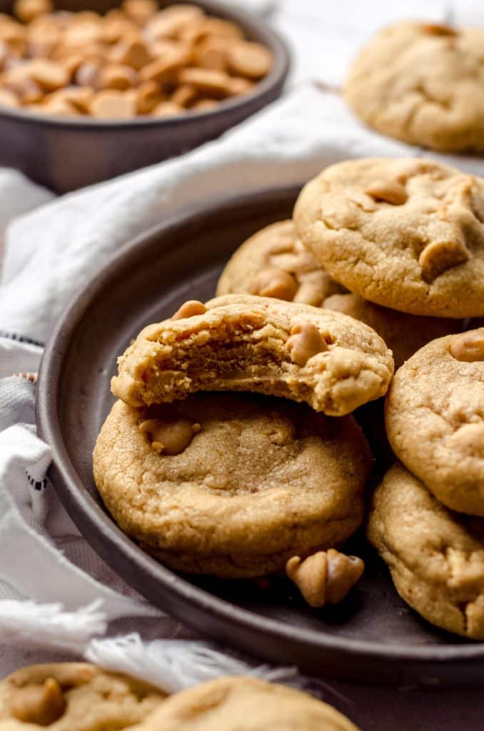 ultimate peanut butter cookies on a plate with a bite taken out of one
