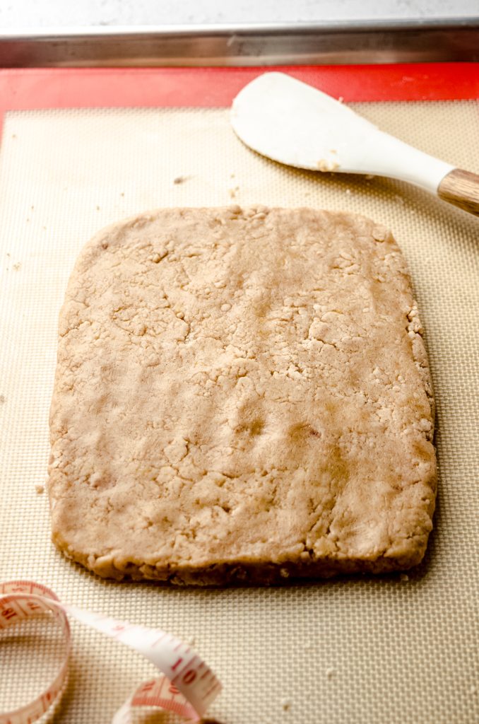 The dough for biscotti pressed into a slab on a baking sheet.