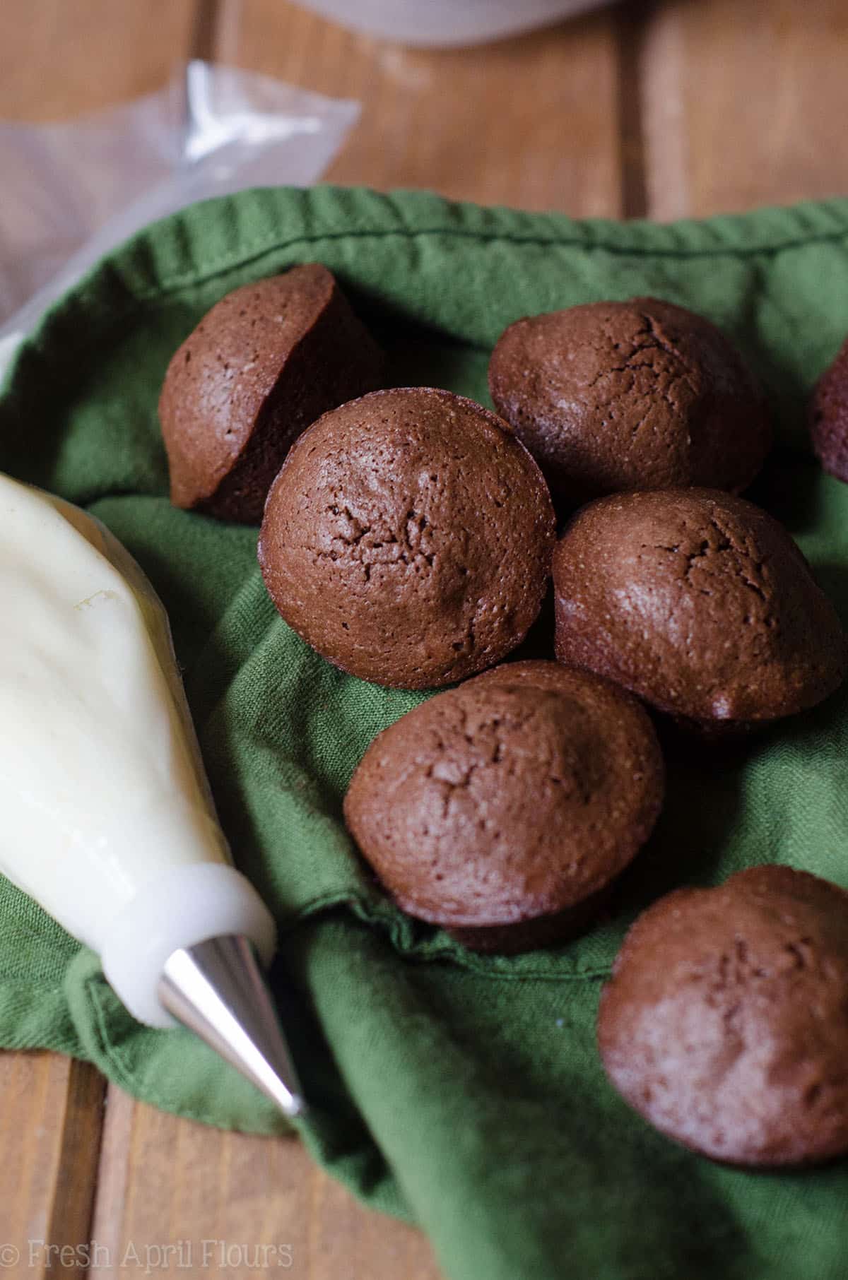 brownie bites with a bag of icing prepared to make football brownie bites