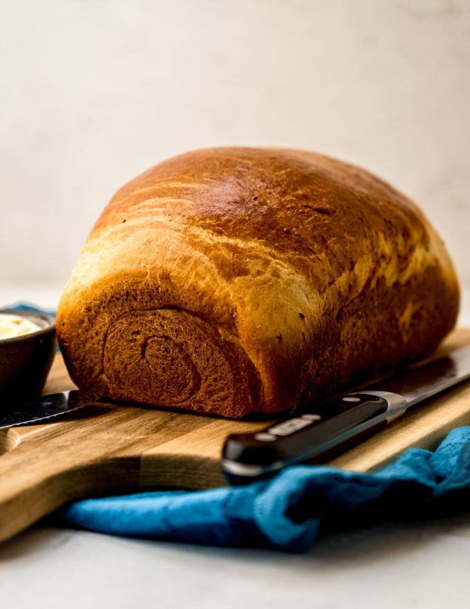 A photo of a loaf of anise bread on a cutting board.