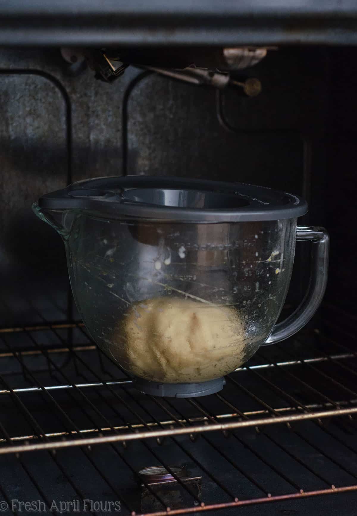 bowl of anise bread dough in a bowl rising in the oven