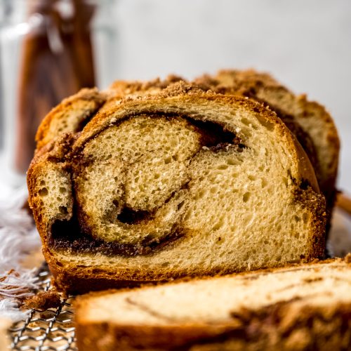 A loaf of cinnamon babka on wire rack.