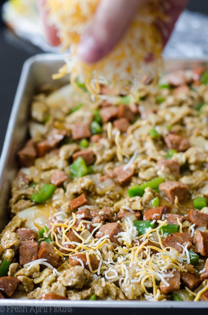 Enchilada Breakfast Bake: Seasoned scrambled eggs and vegetables combined with spicy chorizo, and layered between corn tortillas and enchilada sauce for an easy and flavorful breakfast dish.