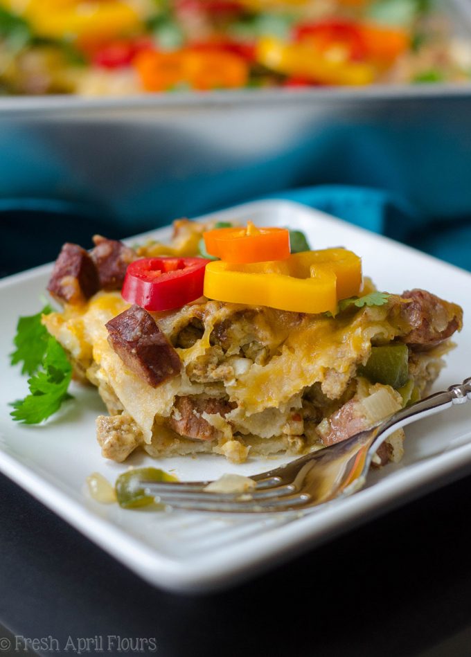 Enchilada Breakfast Bake: Seasoned scrambled eggs and vegetables combined with spicy chorizo, and layered between corn tortillas and enchilada sauce for an easy and flavorful breakfast dish.