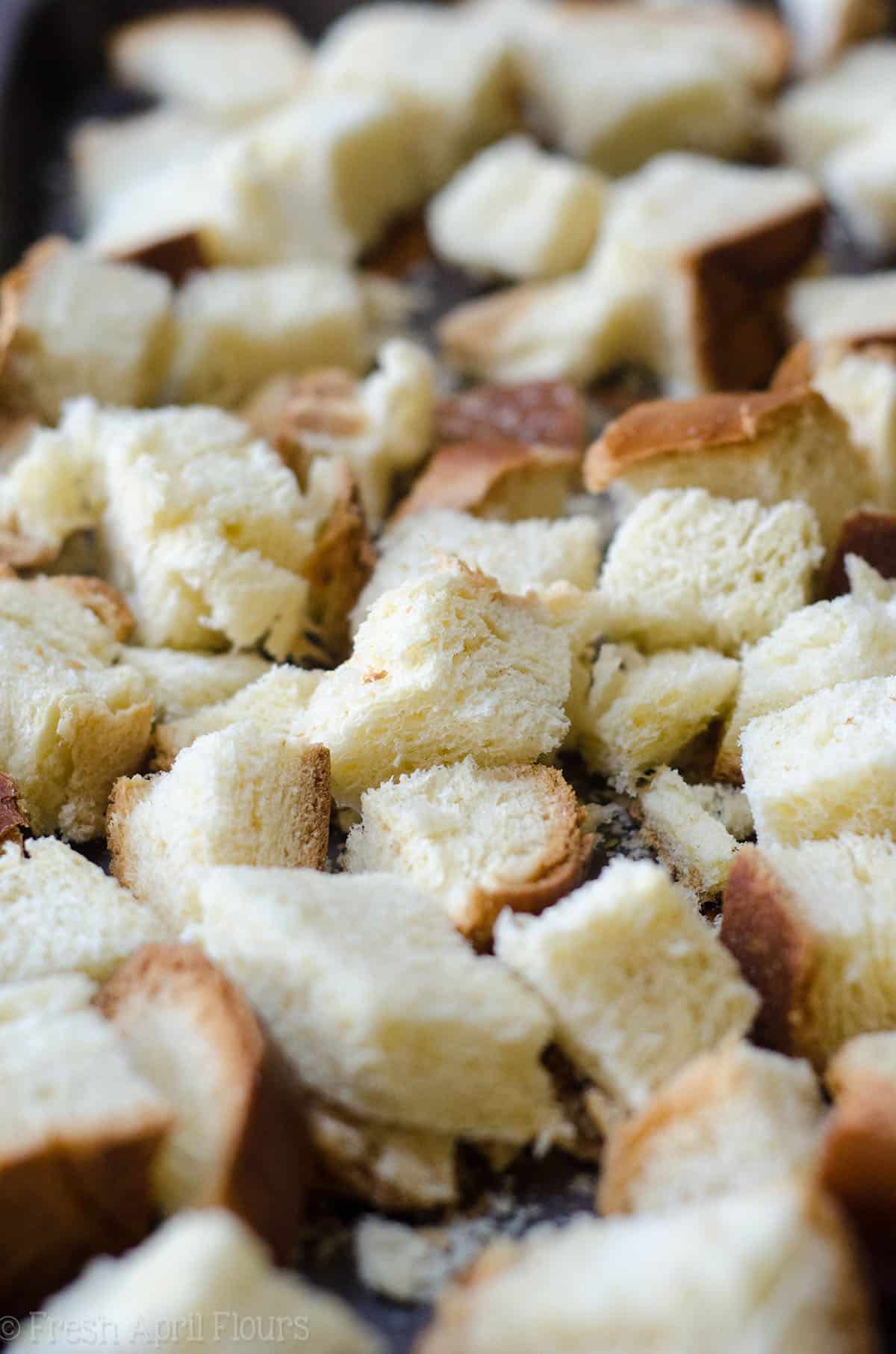 stale bread cubes on a baking sheet