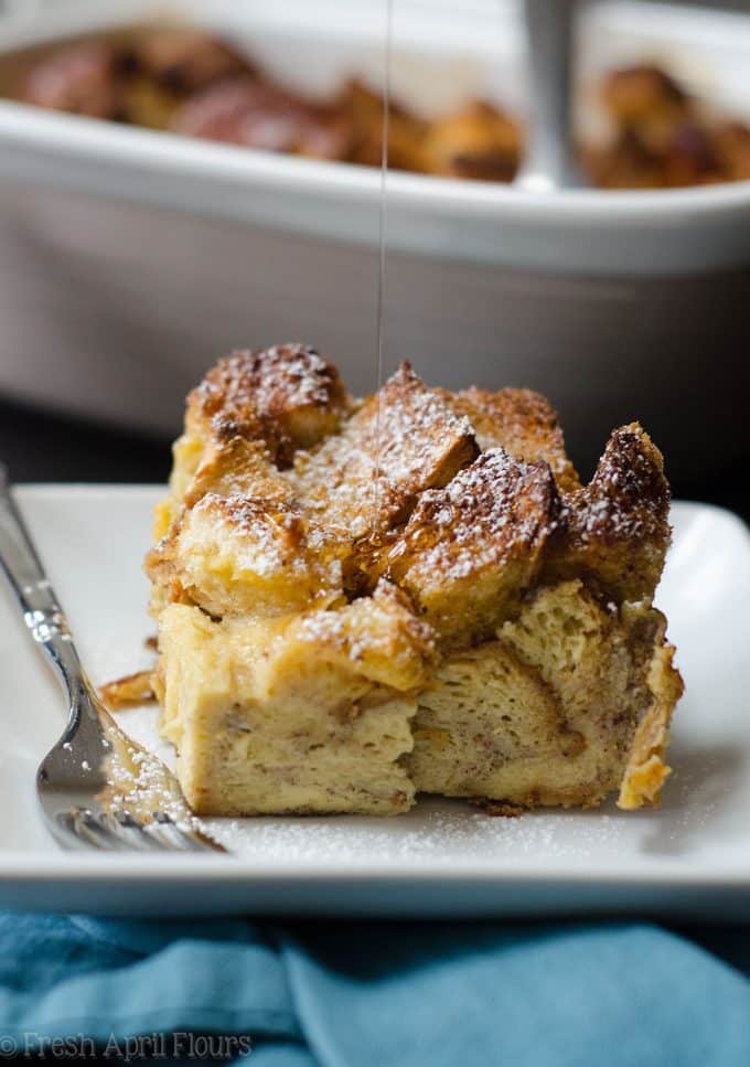 french toast casserole on a plate with syrup dripping onto it