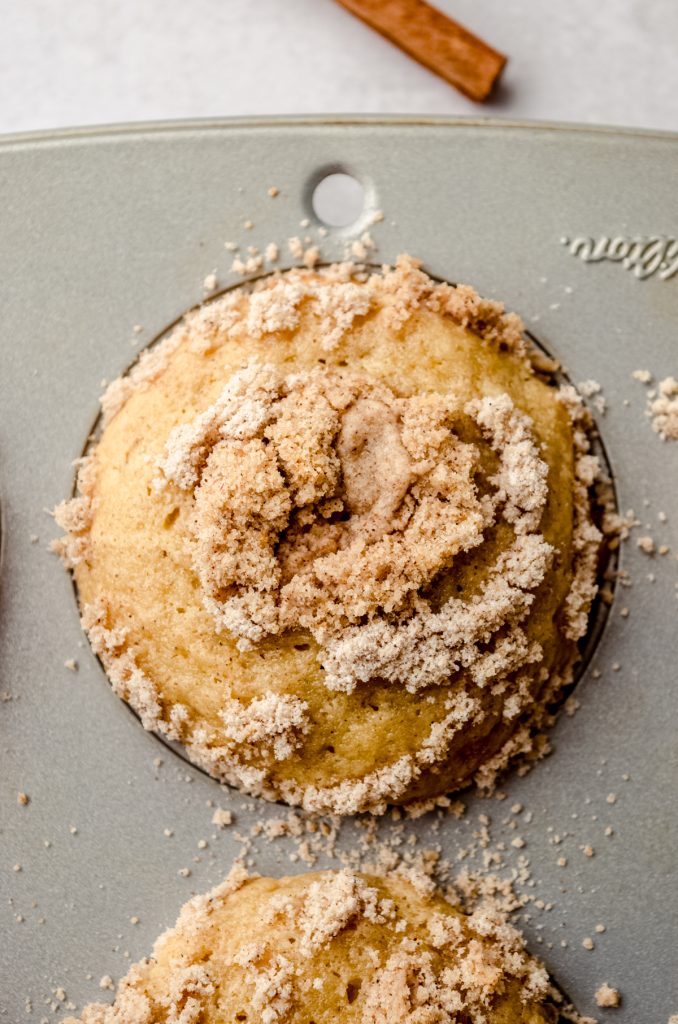 Aerial photo of a cinnamon streusel muffin in a baking pan.